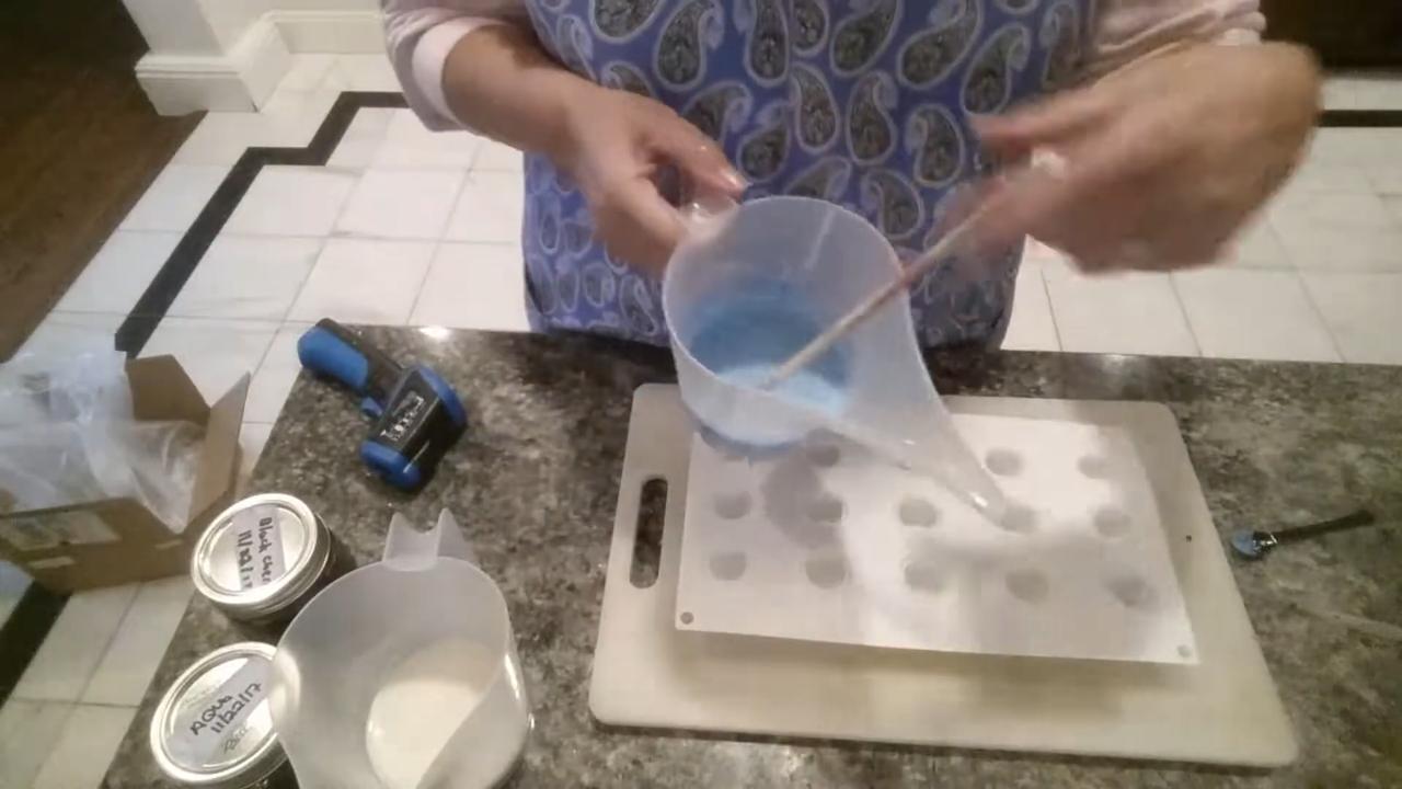 Pouring blue soap into a ball mold for planet embeds