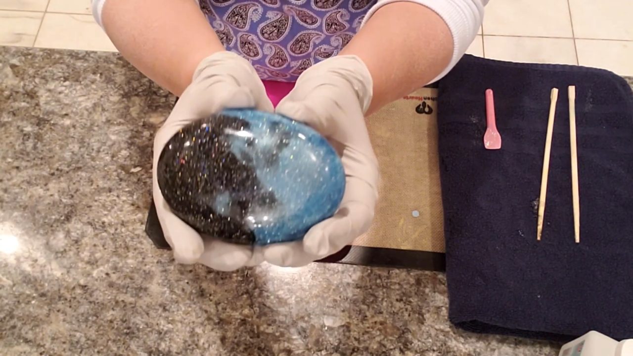 Finished charcoal galaxy melt and pour soap with blue swirls and bio glitter