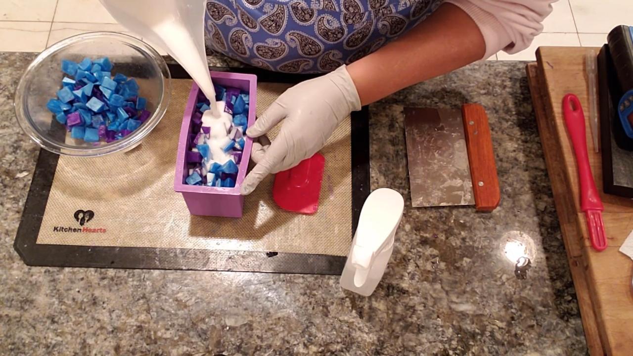 Pouring white shea butter soap over the embeds