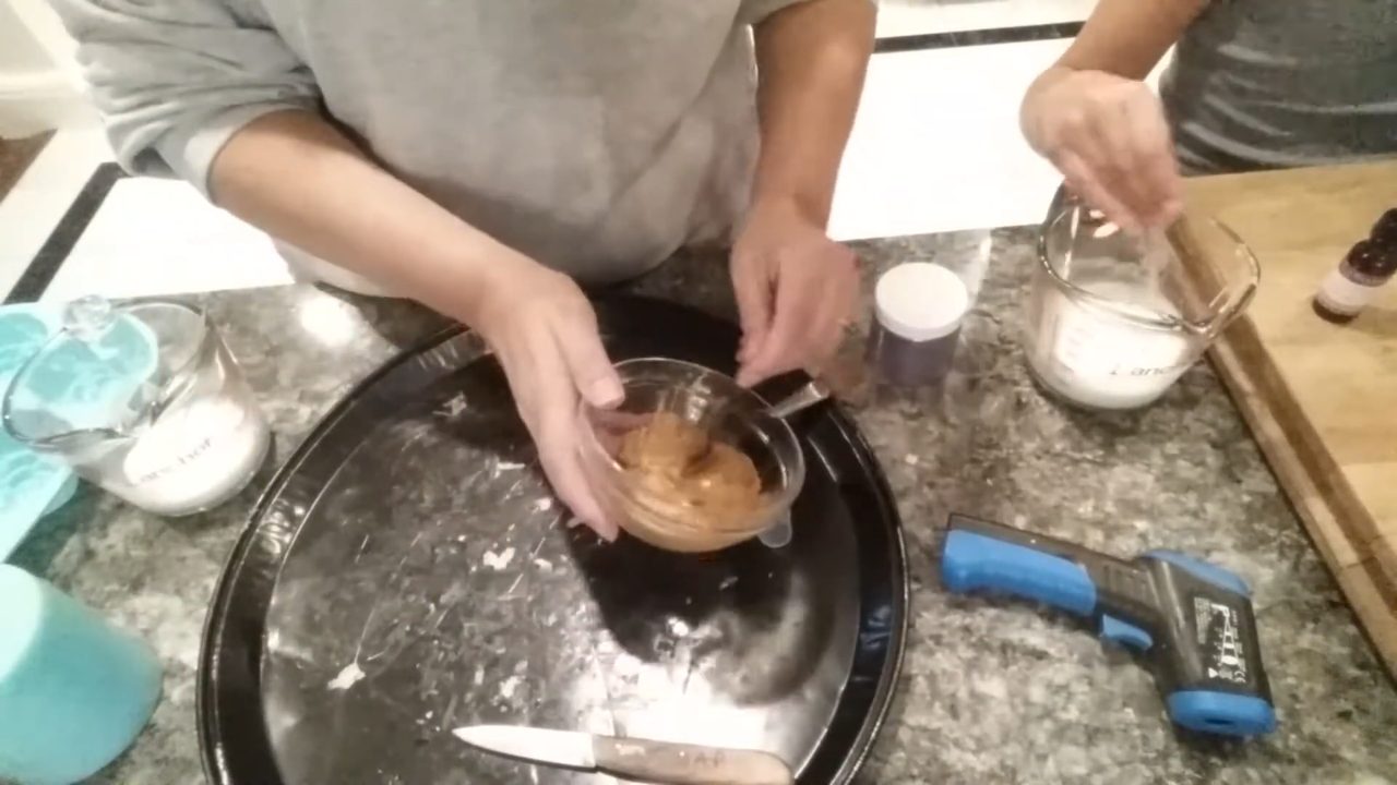 Mixing gold mica into melted soap for the cupcake base