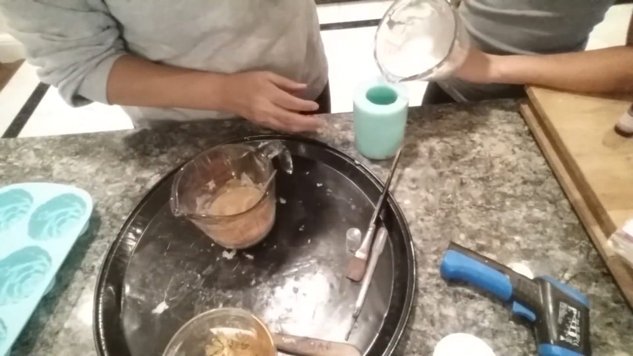 Pouring white soap into the frosting section of the cupcake mold