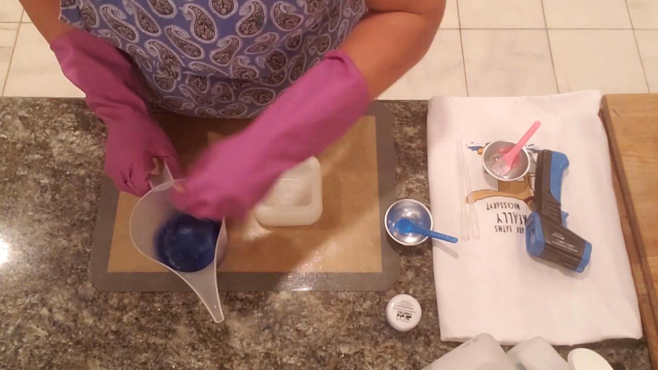Pouring blue glitter soap into the square flower mold