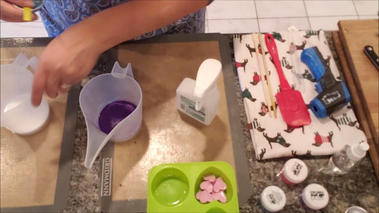 Mixing violet mica into melted shea butter soap base