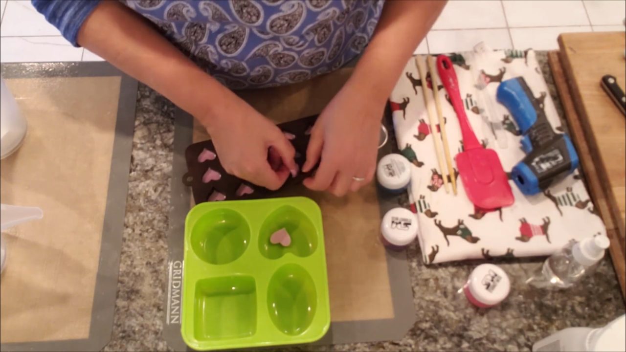 Unmolding pink soap heart embeds