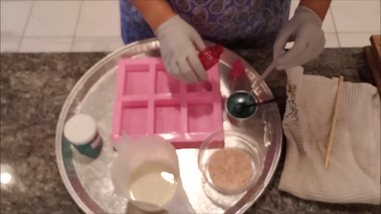 Adding mica mixed with alcohol to melted shea butter soap base