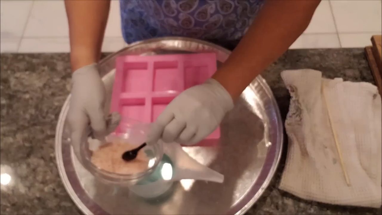 Stirring coarse pink Himalayan salt into melted soap base