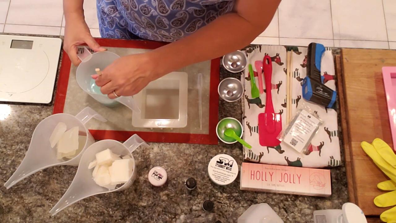 Pouring the green layer into a square soap mold