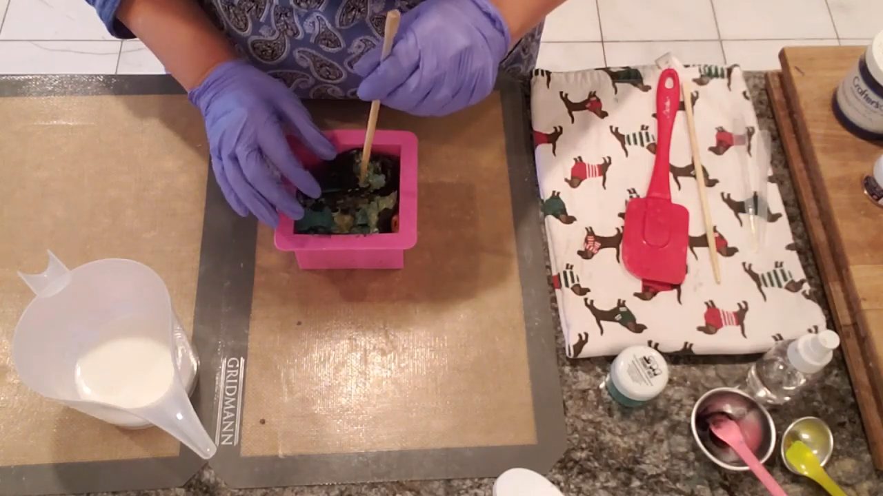 Poking holes in the rolled soap with a skewer before the shea butter pour