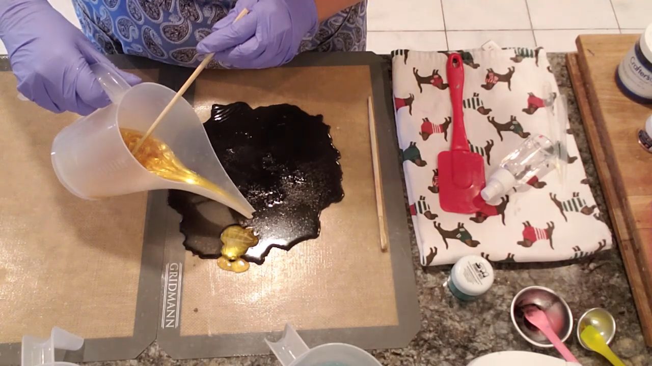 Pouring King Midas gold soap over the black charcoal layer