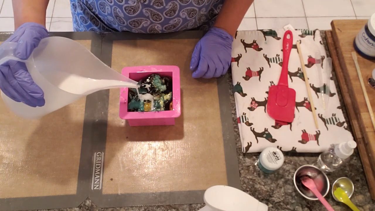Pouring hot shea butter melt and pour soap over the rolled soap in the mold