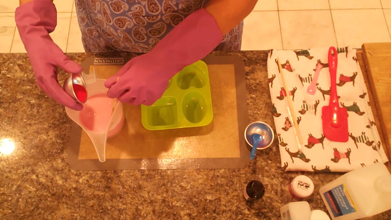 Adding red jojoba beads to cooled pink shea butter soap