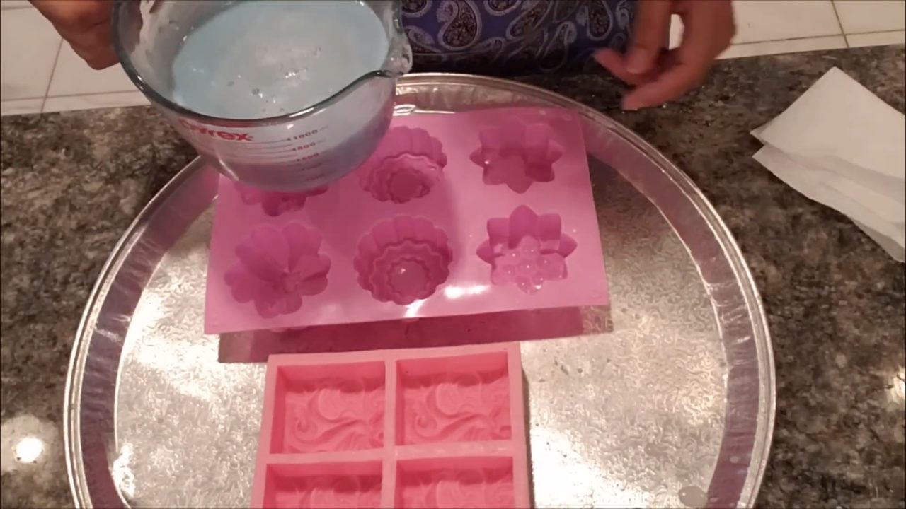 Pouring blue kaolin clay soap into a flower soap mold