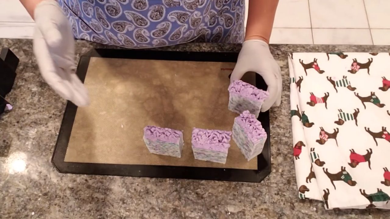 Cut lavender confetti melt and pour soap bars with piped purple frosting