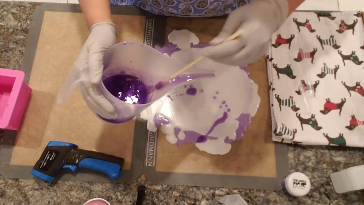 Pouring another purple layer over the white and purple soap