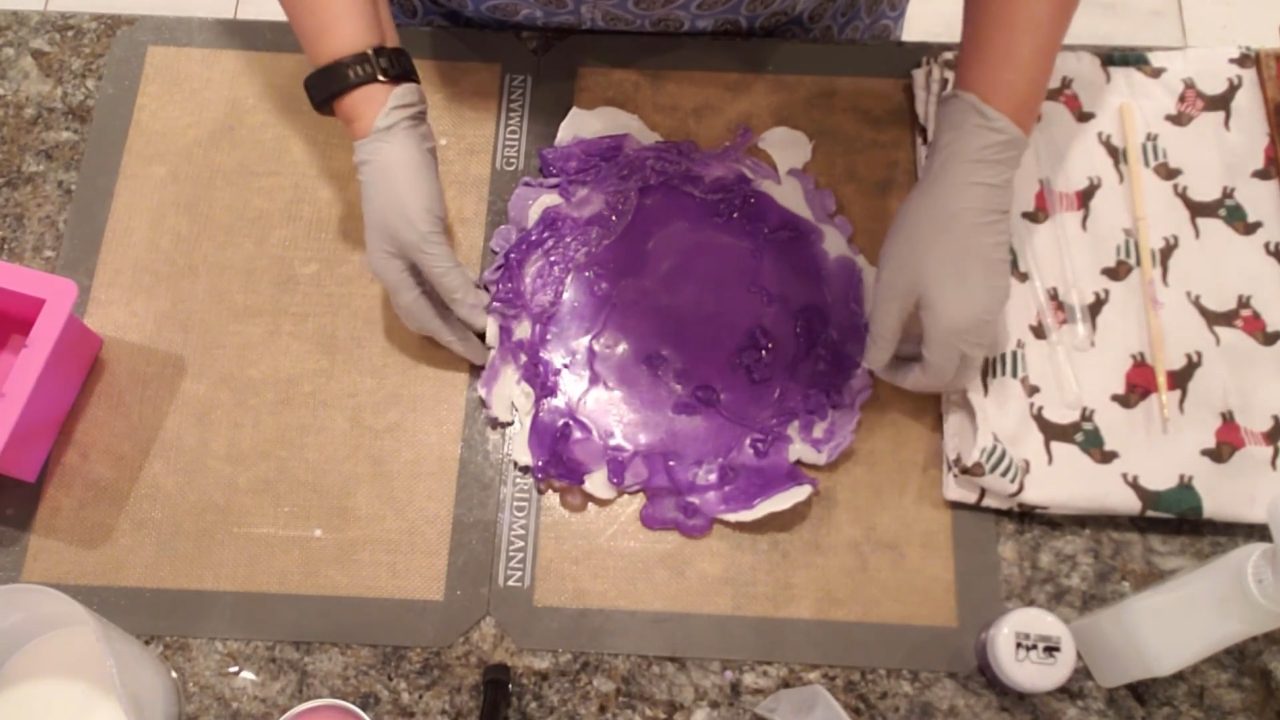 Set purple and white melt and pour soap layers on a silicone mat