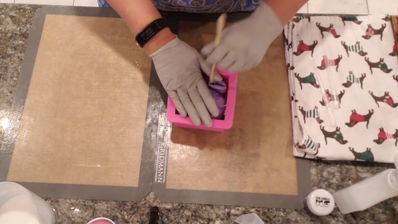 Pressing the rolled soap into a square silicone mold
