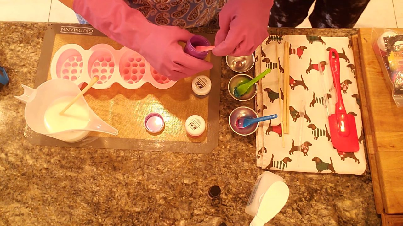 Mixing purple, blue and pink mica with alcohol for massage bar soap