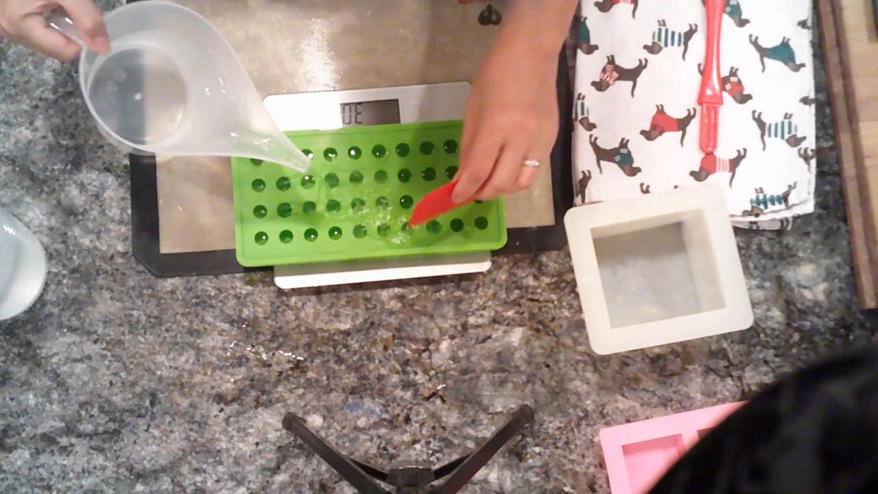 Spreading water into a ball mold with a spatula