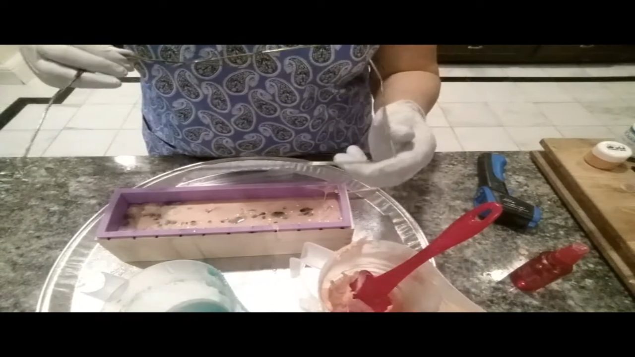 Swirling melt and pour soap in a loaf mold with a bent hanger swirl tool