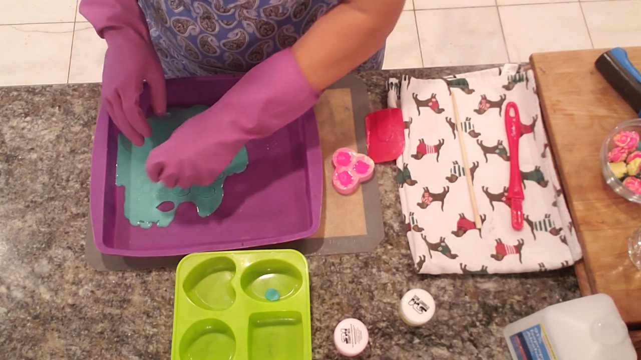 Cutting leaves from a thin layer of green soap with a fondant cutter