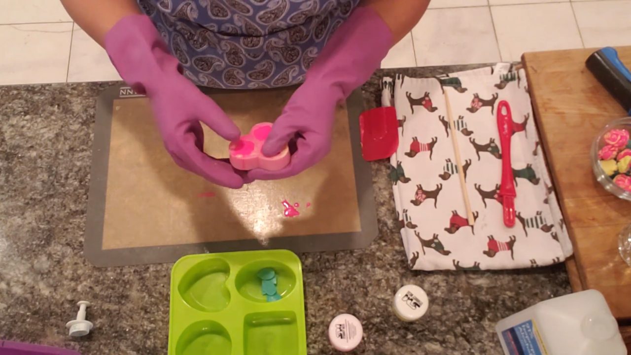 Popping mini rose soap embeds out of the silicone mold