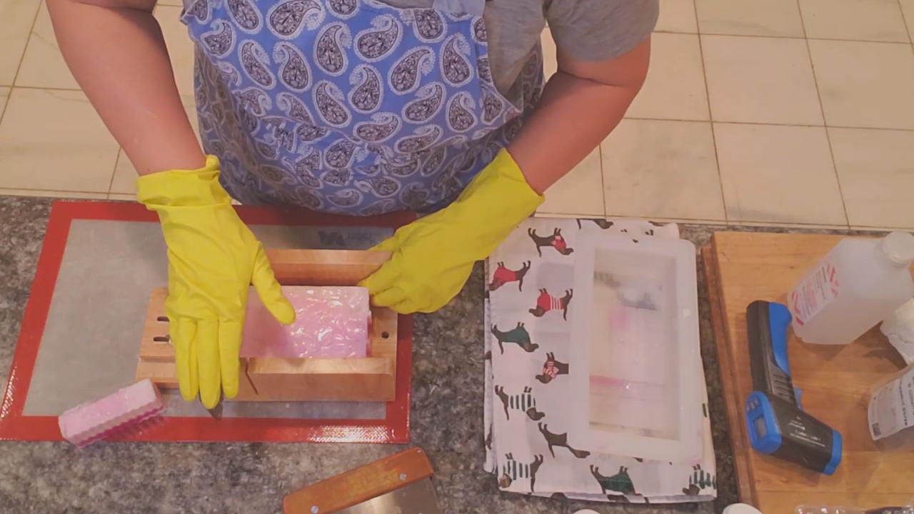 Cutting the pink soap loaf into bars