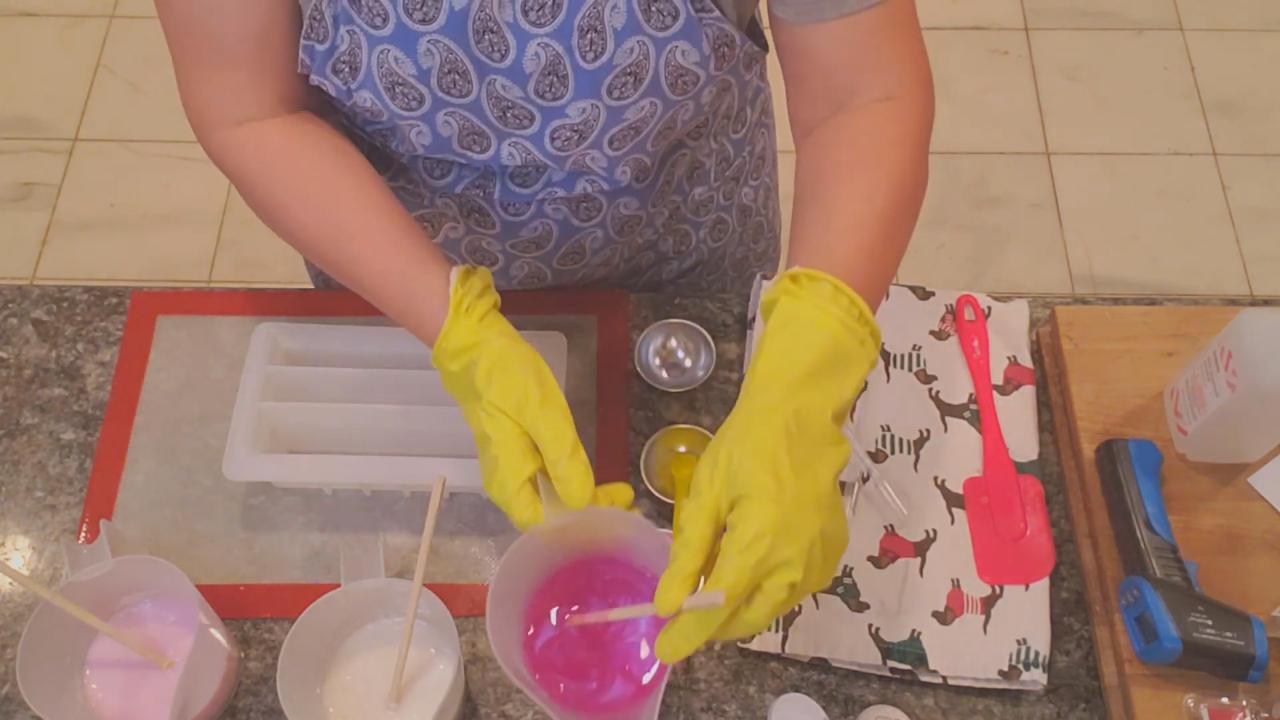 Pouring soap into a loaf mold with dividers