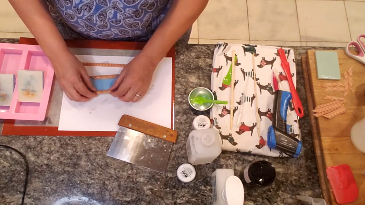 Cutting soap rope pieces to make a frame around the picture soap