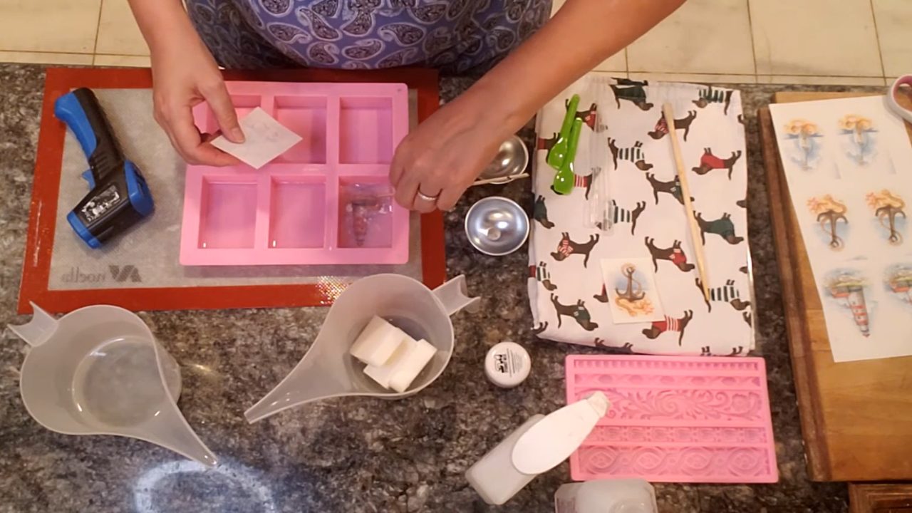 Placing a water soluble paper picture face down in clear soap