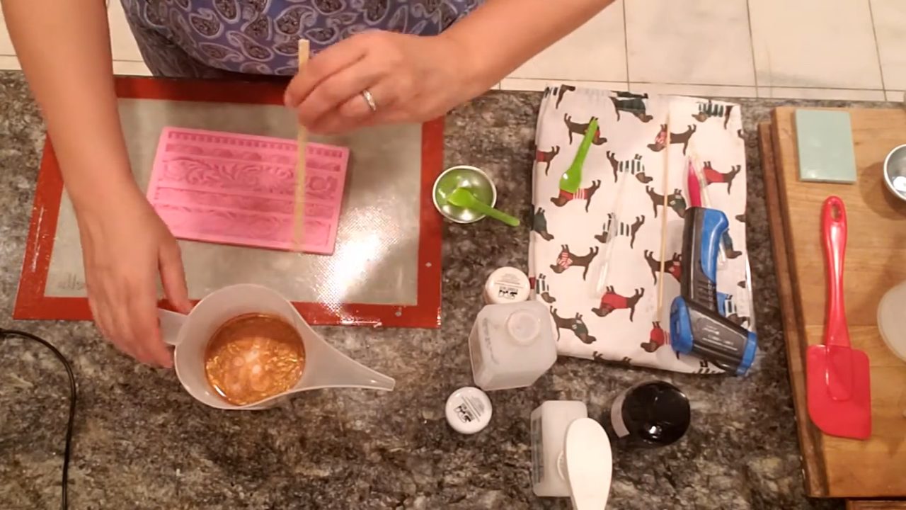 Pouring bronze soap into a rope border fondant mold