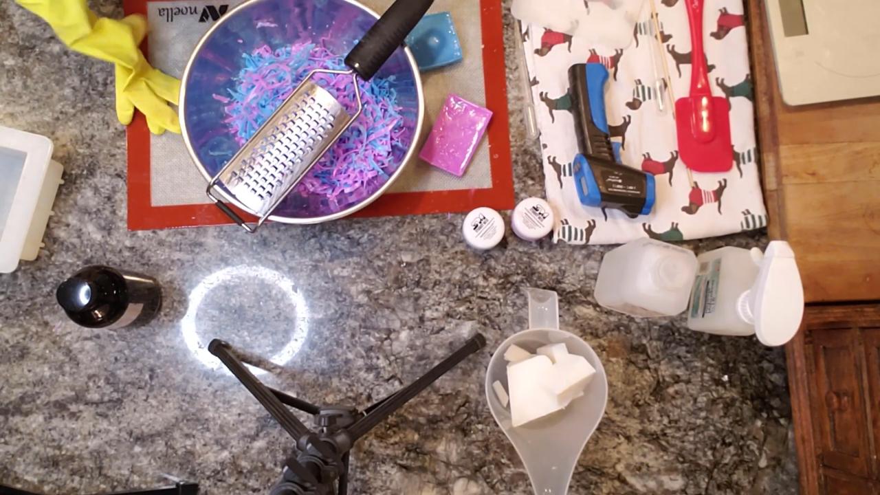 Grating colored soap into confetti with a zester