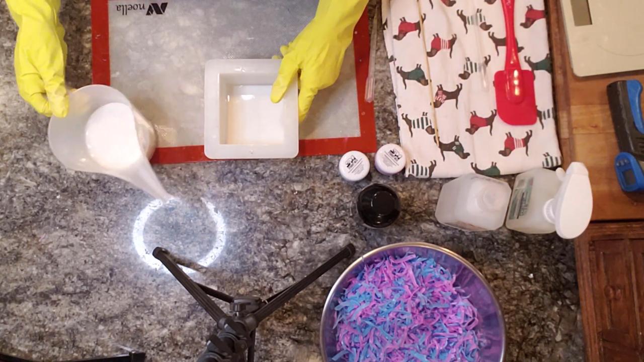 Pouring white shea butter soap into the mold