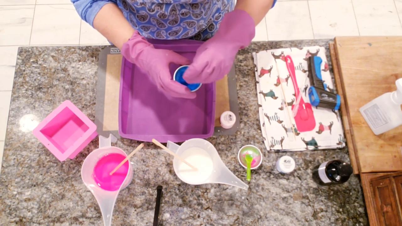 Mixing neon pink and blue mica into melted soap