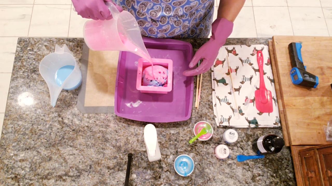 Pouring pink and blue soap over the ball