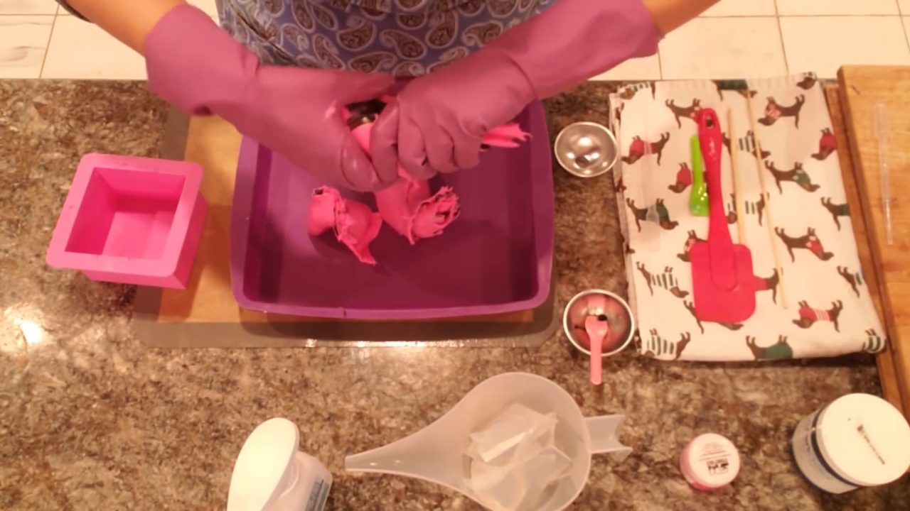Folding and twisting the pink and black soap slab