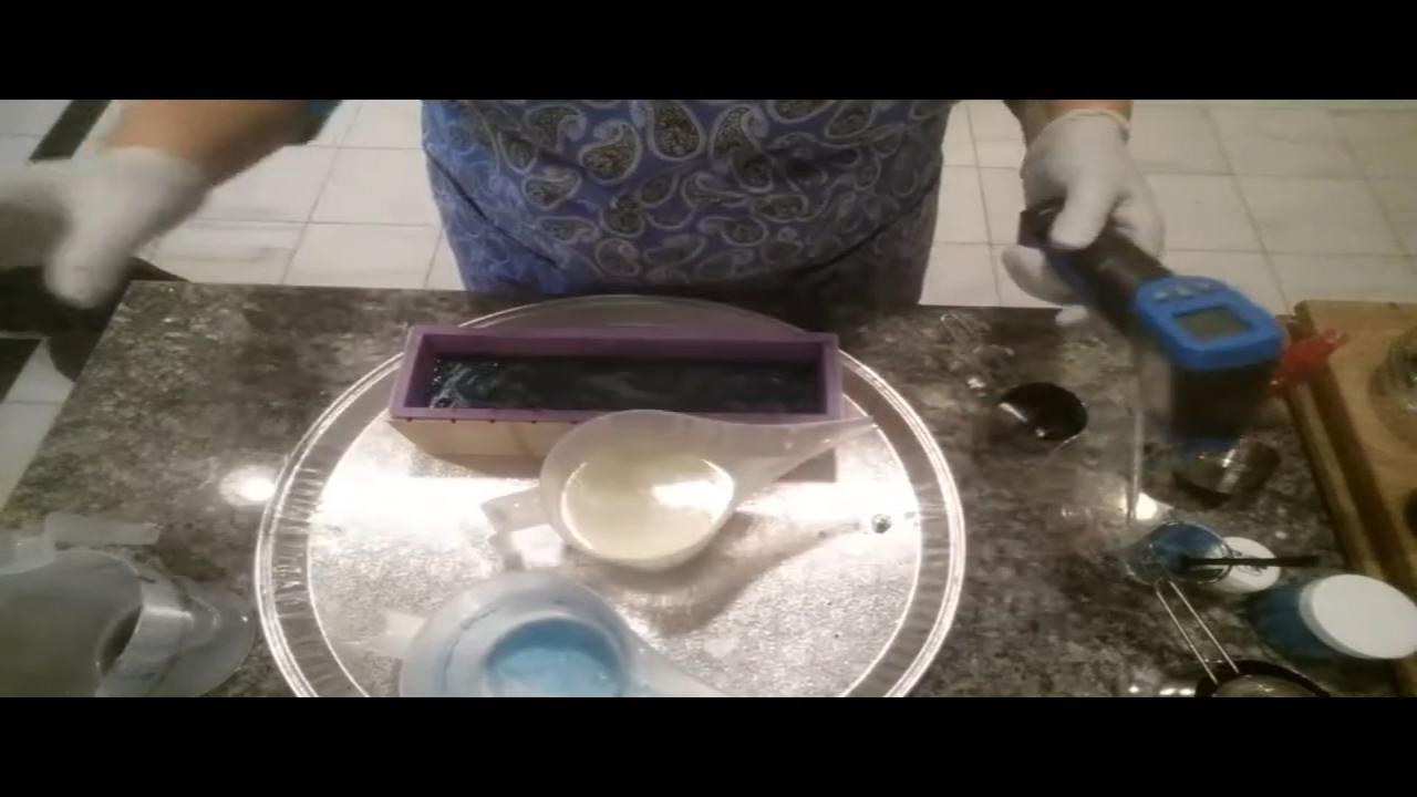 Pouring blue soap into the black layer