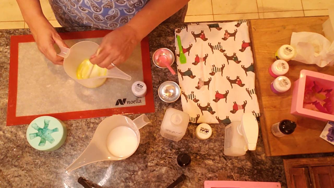 Mixing yellow mica into melted shea butter soap