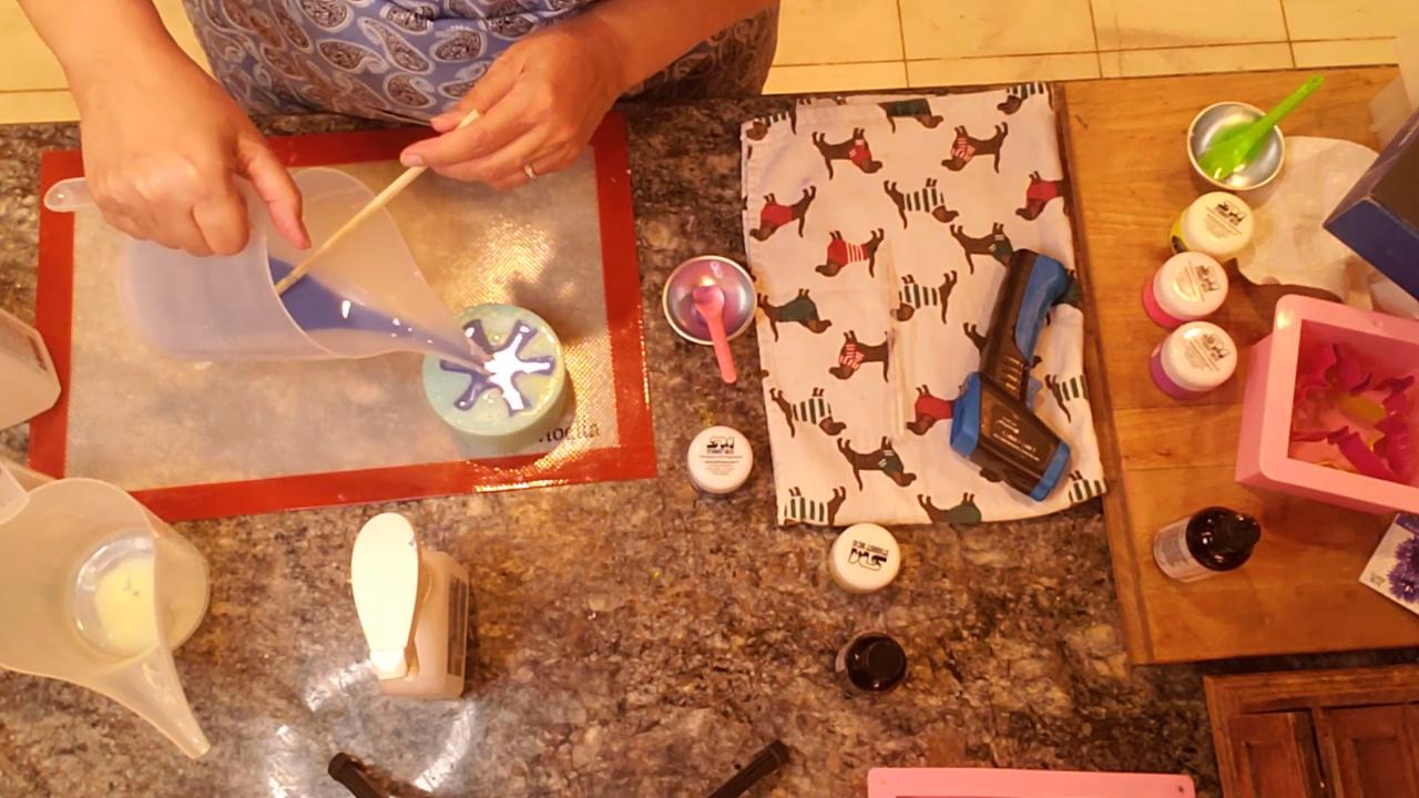 Pouring icy blue soap over the yellow layer