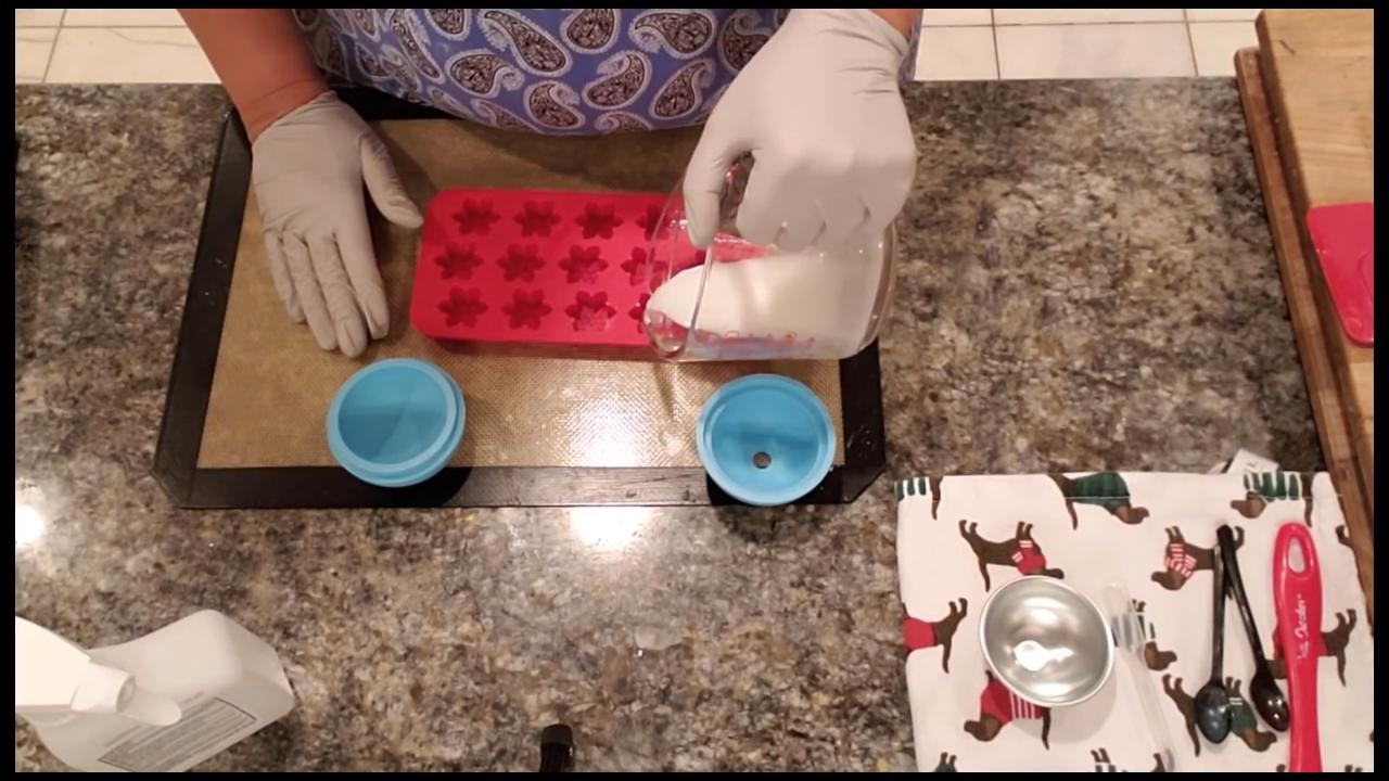 Pouring white soap into a snowflake mold