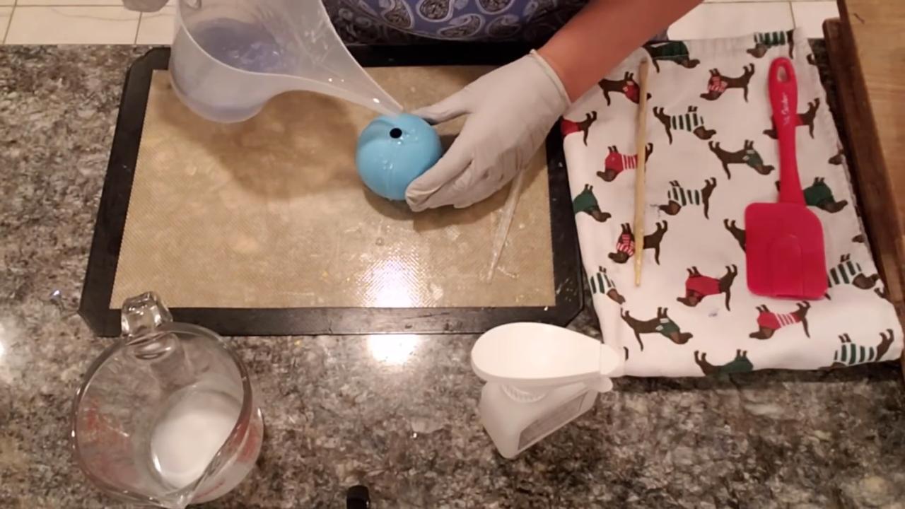 Pouring blue soap into the ball mold
