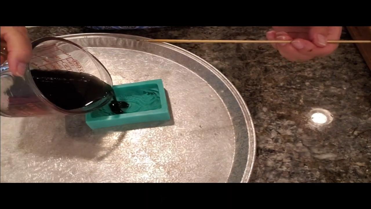 Pouring black melt and pour soap into the dragon eye mold