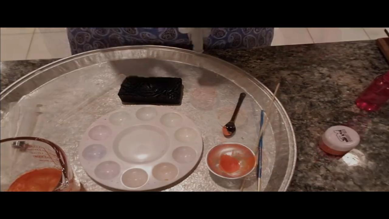Paintbrush, mica palette and melted soap for painting