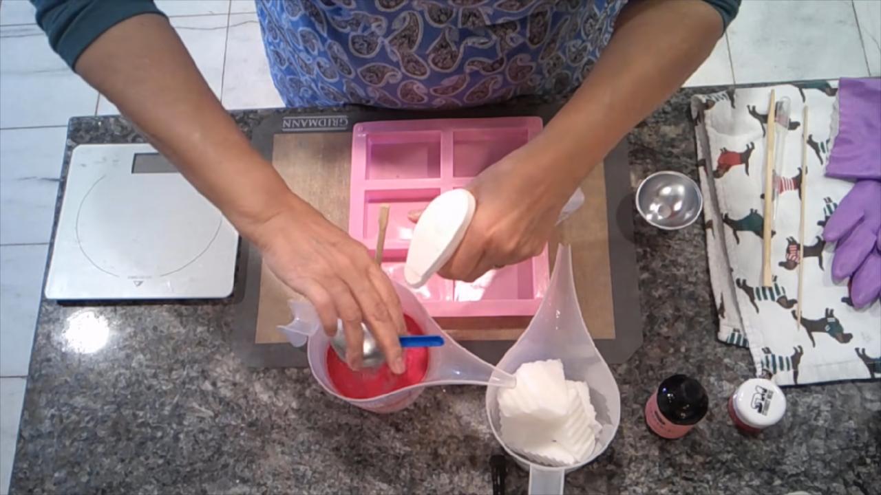 Pouring the first red layer into a cavity mold