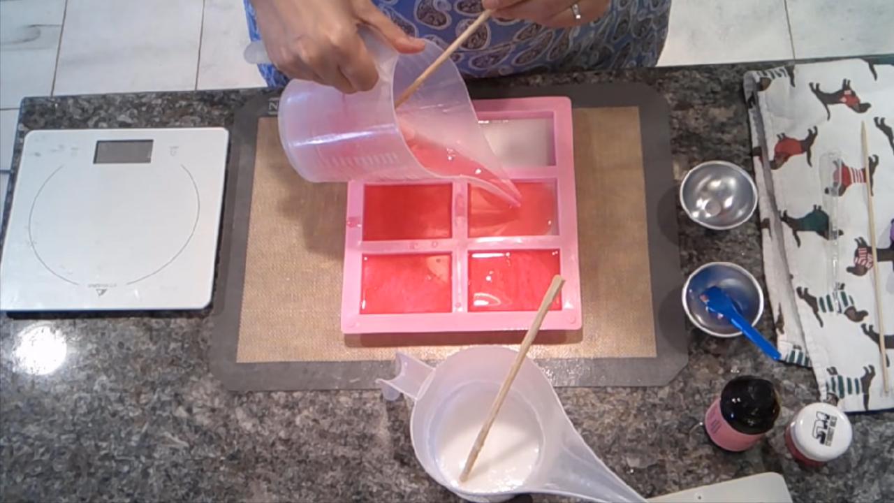 Pouring the top red layer for candy cane embeds