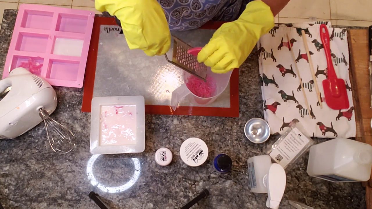 Grating pink soap into shavings for the soap frosting sprinkles