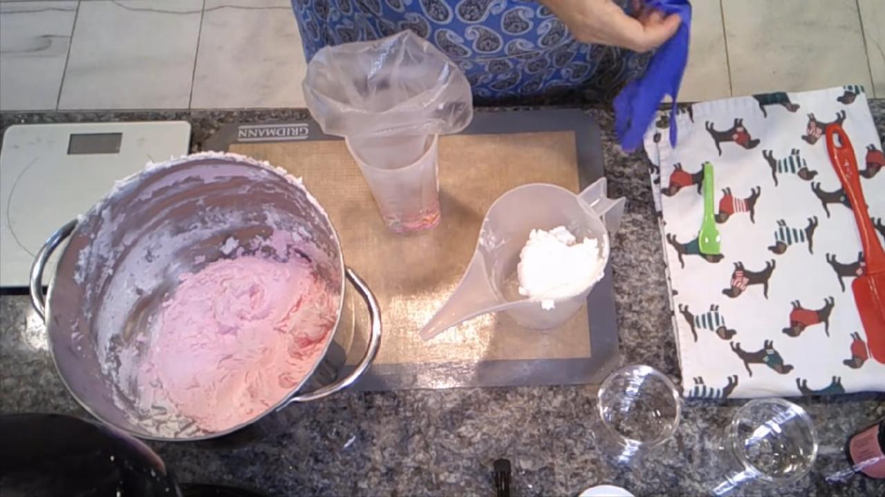 Filling a piping bag with pink and white sugar scrub
