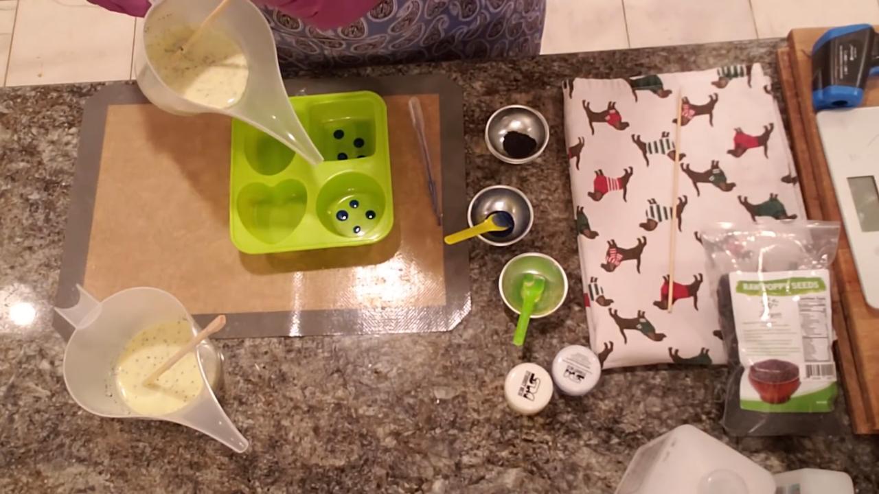 Pouring poppy seed soap over the blue drops