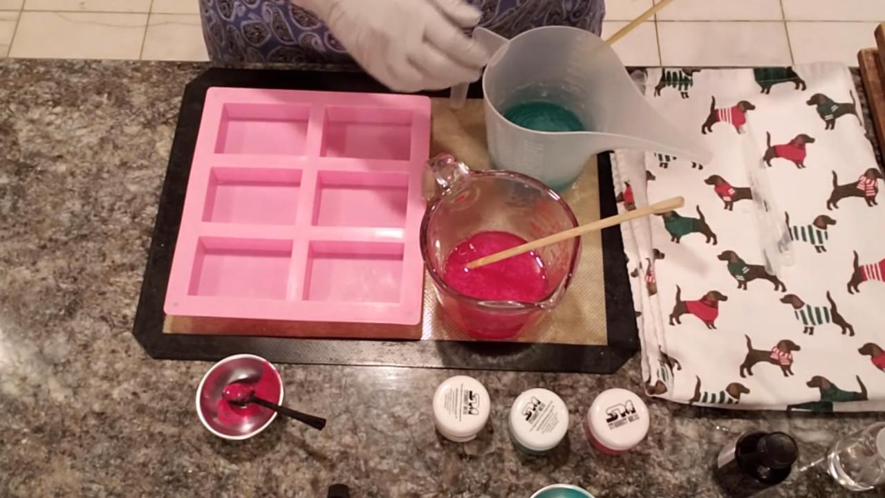 Pouring red and teal soap into a cavity mold