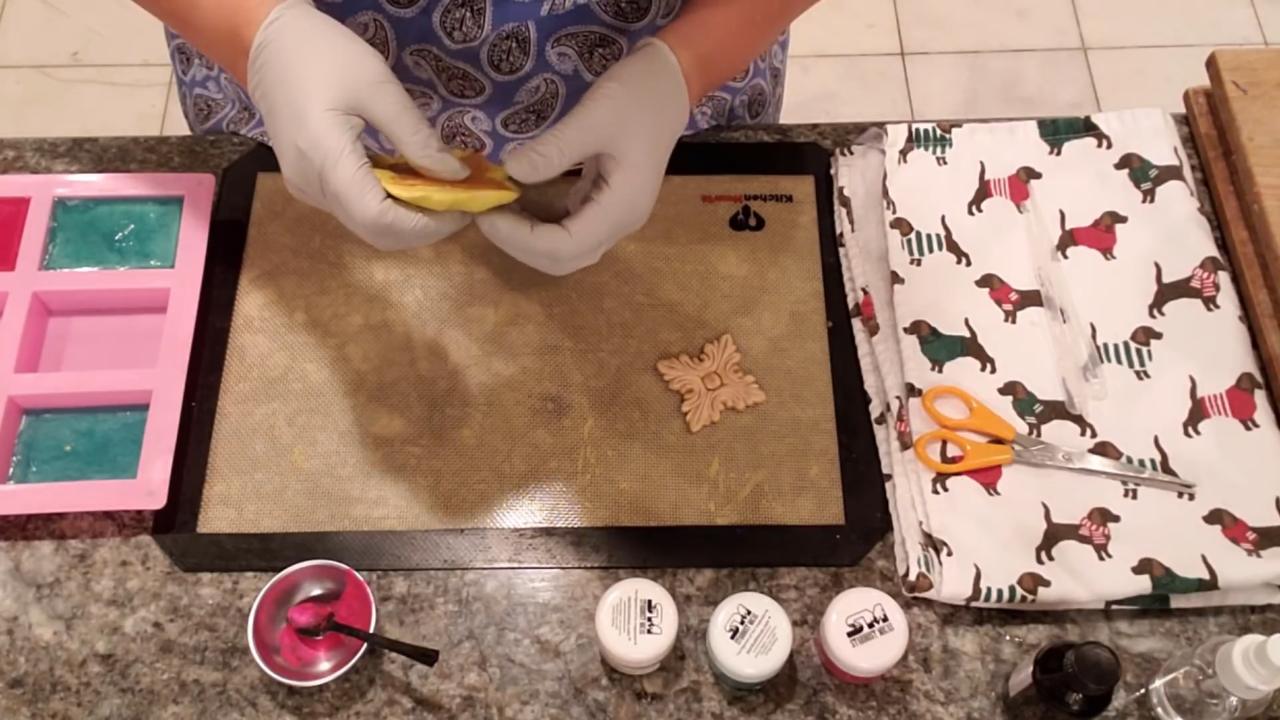 Pouring gold soap into the putty mold