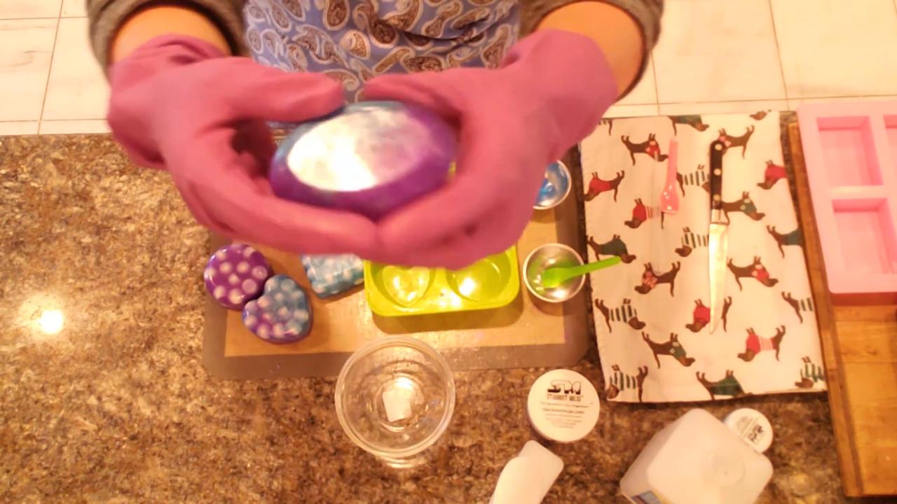 Finished melt and pour soap with white embeds glowing through clear soap